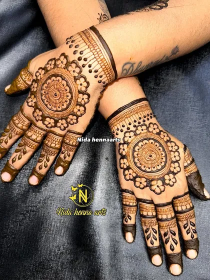A classic and elegant mandala or "tikki" design on the back of the hands. This symmetrical style is timeless and perfect for any festive occasion or celebration.