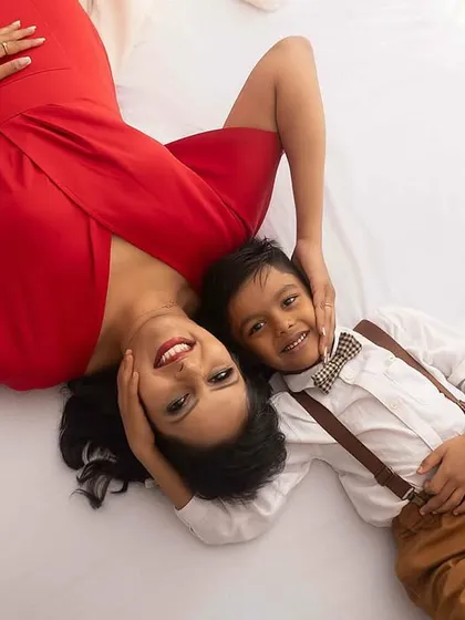 A quiet moment of connection. Lying down together, this mother and son share a look that is both peaceful and full of love.