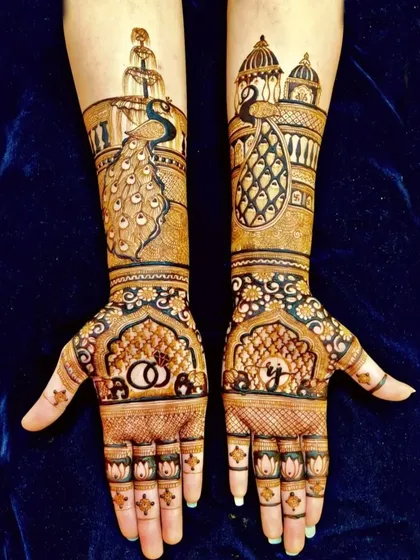 A unique design with peacocks and palace architecture on the arms, and wedding rings and a proposal silhouette on the palms.