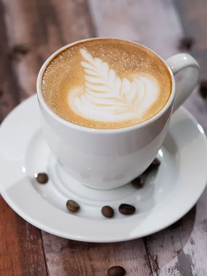 Another stunning example of latte art, this time a rosetta pattern. We teach different pouring techniques so you can get creative with your coffee.