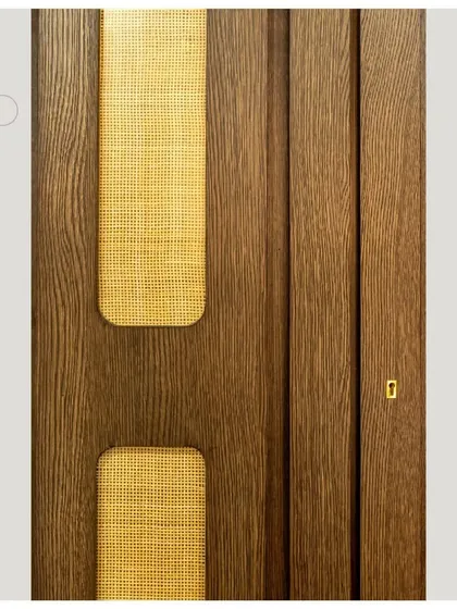 A detail shot showcasing the intricate work of veneer and fabric inlay in a custom furniture piece.