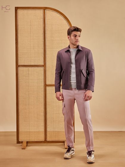 Move beyond the basics with elevated hues for the season. This look pairs a deep maroon shacket with muted pink trousers, showcasing a confident use of color in contemporary menswear.