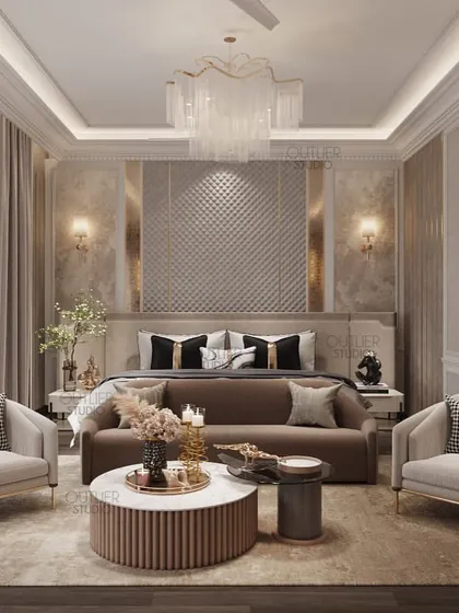 This bedroom is a vision in neutral tones. A large seating area with a round coffee table sits at the foot of the bed, creating a luxurious suite-like feel. The textured headboard wall adds a touch of glamour.