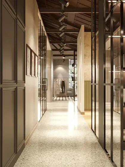 This rendering shows a hallway connecting different "rooms" within the store. The paneled walls and glass partitions guide the customer journey while offering glimpses of the spaces ahead.