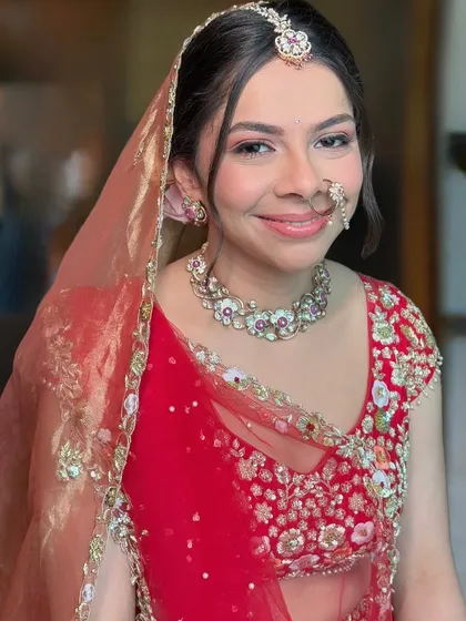 A close-up of Malvika's soft and dreamy wedding look. The focus is on her glowing skin, with a touch of pink on the eyes and cheeks for a fresh, radiant finish.