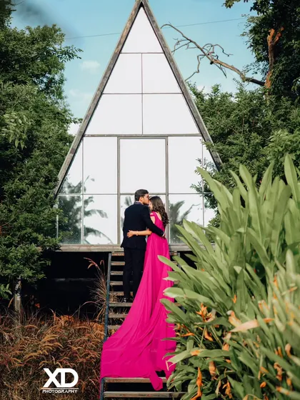 (Hero Item) This is the kind of grand, romantic shot we can create. I captured this moment at a popular Bangalore studio, using the unique A-frame architecture to create a stunning backdrop. The flowing gown, included in my rental outfit collection, adds a perfect touch of drama for a memorable pre-wedding photo.