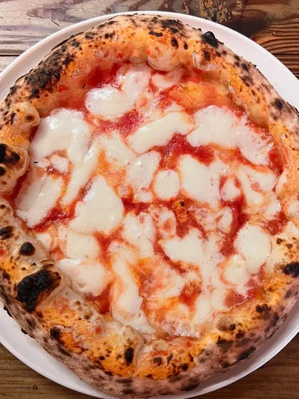 A beautifully charred Margherita, straight from the oven. This is what Neapolitan pizza is all about.