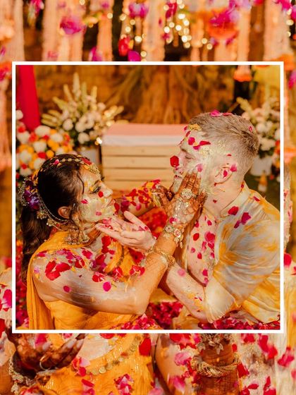 A sweet moment where the bride applies haldi to the groom, surrounded by our colorful floral setup.