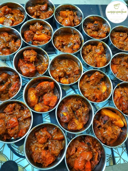 Portioning out my new fried chicken and tomato curry for tiffin orders. Each steel bowl is filled, ready to be part of a complete meal.