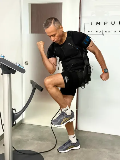 This dynamic movement, a high knee, challenges coordination and core stability, all amplified by the EMS suit.