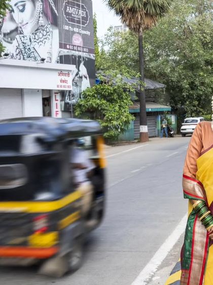 A unique portrait of the bride on a city street, with a passing auto creating a sense of motion and life.