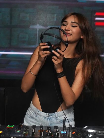 Holding up my headphones, ready for a banger night in Gurgaon. This is my happy place.