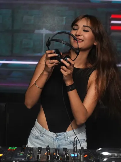 Holding up my headphones, ready for a banger night in Gurgaon. This is my happy place.