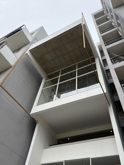 The exterior of the central social core at "The Treehouse," which projects from the main building volume. This element is a key feature of the building's design and identity.