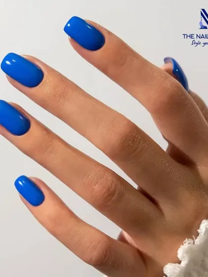A crisp, clean shot of a classic square-shaped manicure in a vibrant cobalt blue. This timeless look is perfect for any occasion and showcases a flawless gel polish application.