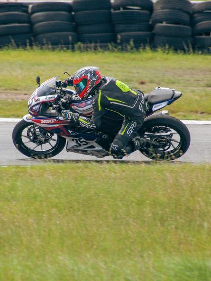 A rider on a race-liveried bike at MMRT. Racing is not a hobby, it's a passion that we help you pursue.