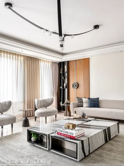 The final design of the Noor Haus living room, featuring a sculptural black light fixture, a stunning marble coffee table, and a calm, neutral palette. Every element was chosen to create a sense of quiet, modern elegance.