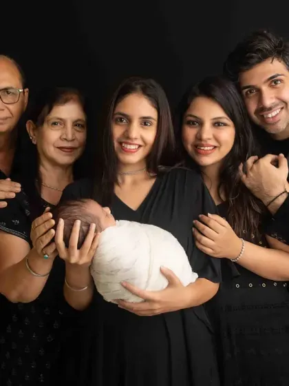 The whole family together, celebrating a new beginning. This beautiful portrait captures the joy and love surrounding the baby, a timeless keepsake for everyone involved.