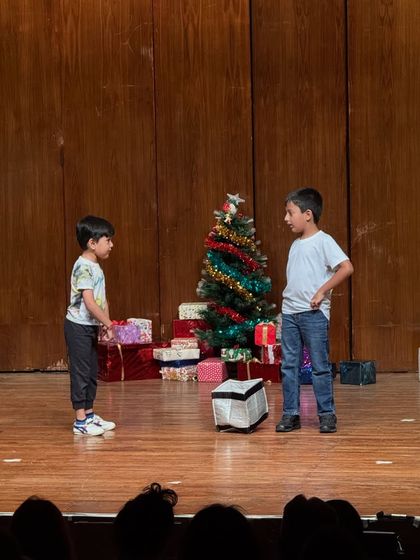 Two students engage in a dialogue-heavy scene, demonstrating their public speaking and memory skills.