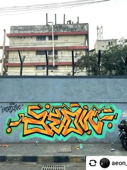 Pure graffiti style in Navi Mumbai. This piece showcases the technical skill of lettering with its sharp, clean lines and vibrant orange and teal colors, representing the core of graffiti culture.