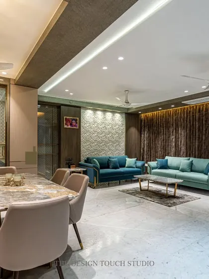 This angle shows the harmonious relationship between the living and dining areas. The consistent use of a warm, neutral palette and elegant lighting ties the entire space together.