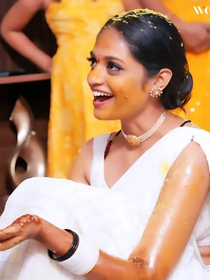 A candid shot of the bride's infectious laughter during her Haldi. These are the unposed, genuine moments that truly tell the story of your wedding day.