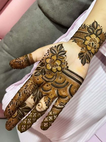 A contemporary floral design with a focus on clean lines and open space. The pattern flows beautifully from the fingers to the wrist.