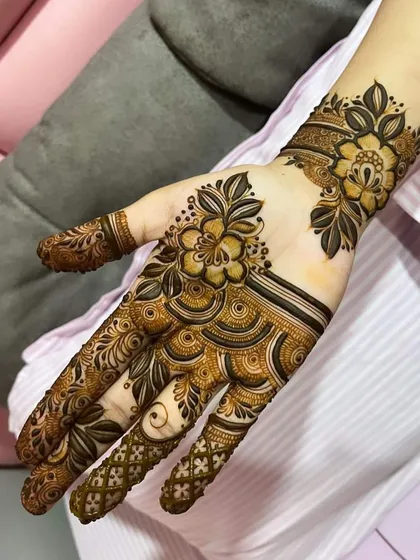 A contemporary floral design with a focus on clean lines and open space. The pattern flows beautifully from the fingers to the wrist.