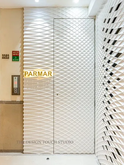 From another angle, you can see how the textured Corian wall panels wrap around the corner, integrating the elevator area and creating a completely immersive and high-end entryway experience.