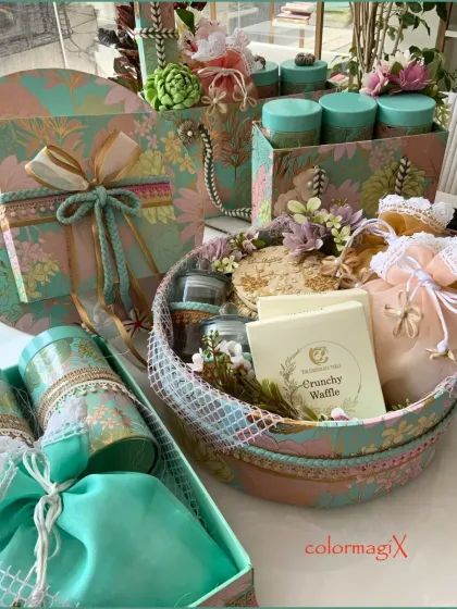 An example of our intricate and luxurious packaging style. This arrangement in soft teal and peach tones, featuring handcrafted boxes, potlis, and baskets, demonstrates the level of detail and elegance we bring to every gift, regardless of the occasion.