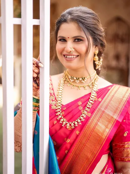 A close-up of the bride's happy smile. Her makeup is radiant and natural, letting her joy be the main focus.