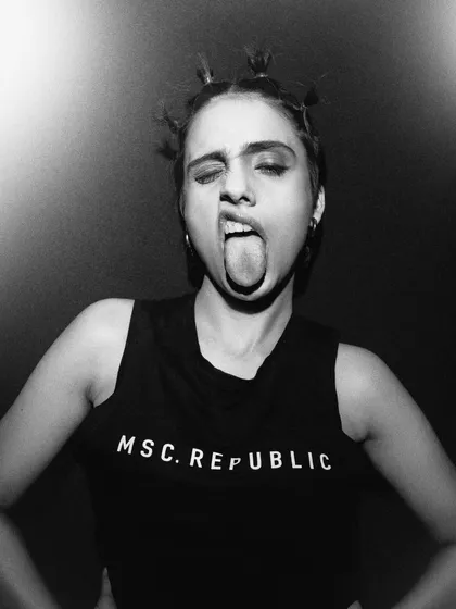 A playful and rebellious moment captured in black and white. This shot shows a different side of the model's personality, adding range and energy to the series.
