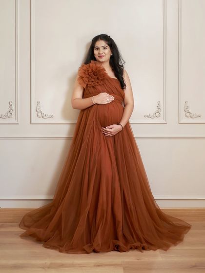 A beautiful solo portrait in our Copper gown. The simple, elegant backdrop of our studio allows the dress and the mama-to-be to shine.