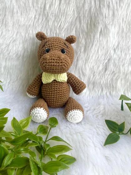 A collection of animal friends made as newborn photo props. This set includes a colorful owl, a lion, a hippo, and a bunny.