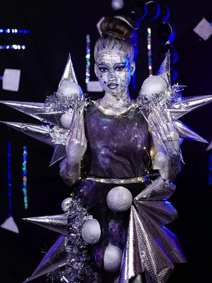 A powerful stance showing the full costume and makeup. You will learn how to conceptualize and execute a complete character look for fashion or fantasy projects.