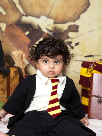 A wider shot of the Harry Potter setup, featuring props like a sorting hat, an owl, and vintage luggage to complete the magical scene.