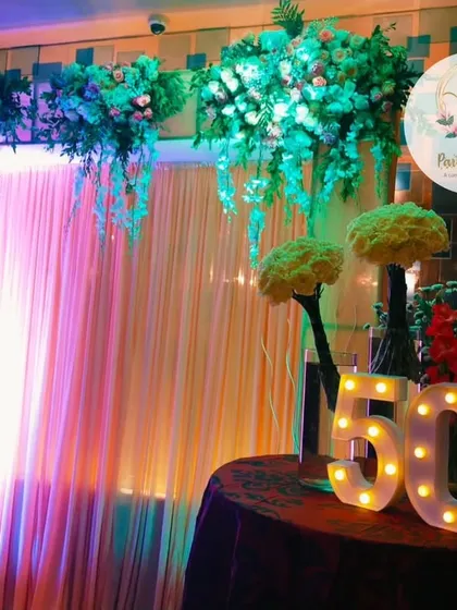 A beautiful setup for a 50th wedding anniversary. We used hanging floral arrangements and a large marquee number '50' to create a celebratory focal point.