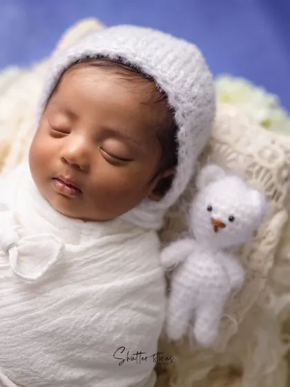 A sweet variation of the white-on-white theme, adding a small teddy bear prop for extra charm.