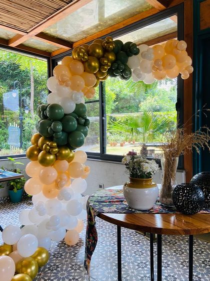 This shot captures the full length of the balloon arch, showing how it creates a dynamic and festive focal point in the room.