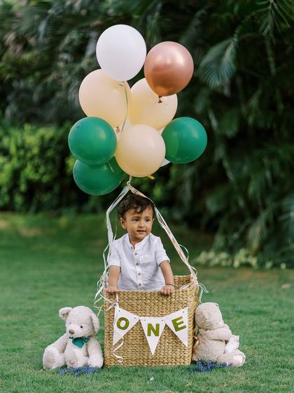 A classic hot air balloon shot for a first birthday. This prop never fails to create a sense of wonder and adventure.