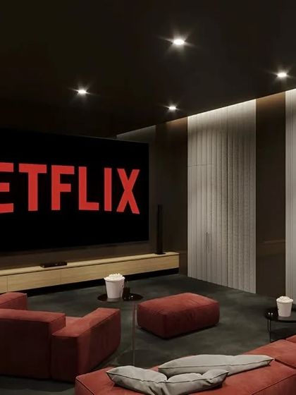 A minimalist home theater setup perfect for a modern home. The design features a large screen, a simple media console, and comfortable, modular seating for a relaxed movie night.