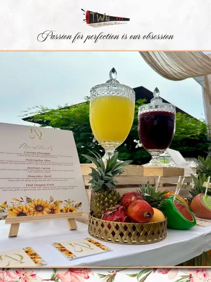 A rustic and elegant mocktail station for a brunch event, featuring fresh fruits and large dispensers of our signature non-alcoholic punches.