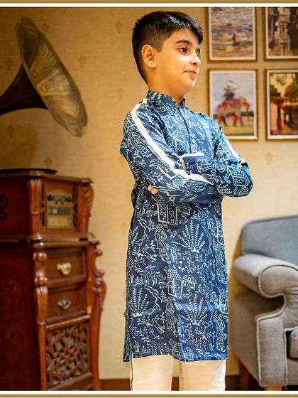 Ready to welcome Bappa for Ganesh Chaturthi. This young client looks sharp and festive in our blue printed kurta with a modern white stripe detail.