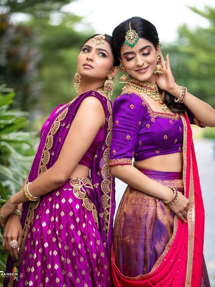 A back-to-back pose that creates a striking visual contrast and showcases the intricate details of both outfits.