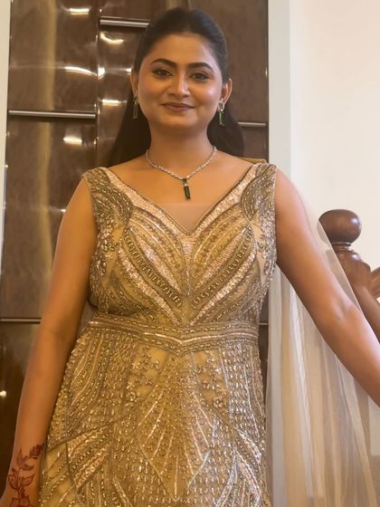 A full view of the elegant engagement gown. The makeup is kept sophisticated and clean to balance the heavily beaded dress.