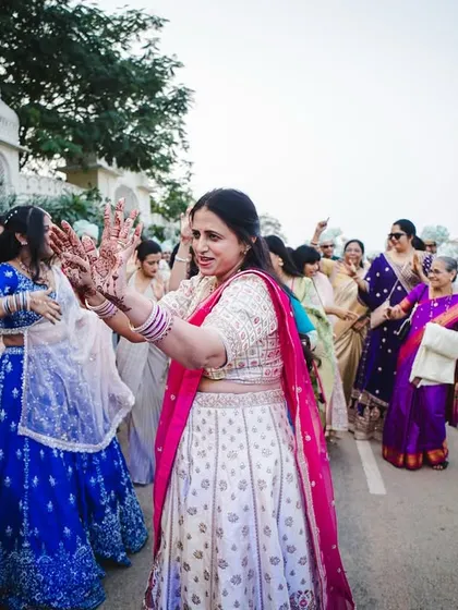 The mother of the groom showing off her moves as the baraat arrives.