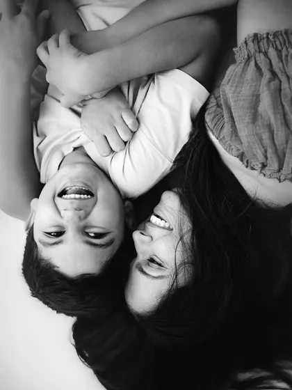 The same joyful moment as before, now in classic black and white. Stripping away the color emphasizes the pure emotion and connection in their laughter.