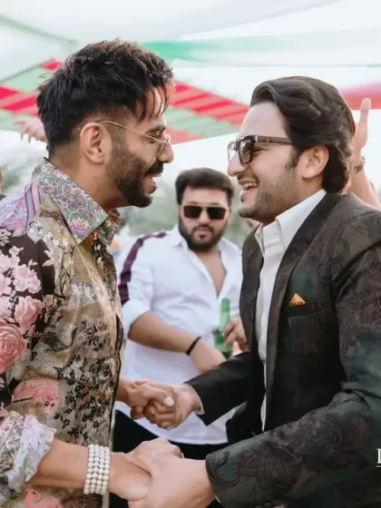 A warm greeting between the groom and a guest, singer Sukhbir. I manage events that often include high-profile guests, ensuring a smooth and enjoyable experience for everyone.