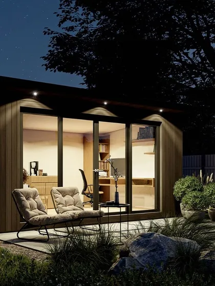 Our modular prefab rooms can be designed as quiet, standalone home offices or studios. This night view highlights the warm, inviting interior and efficient use of space, showing how a compact structure can become a functional and stylish extension of your home.