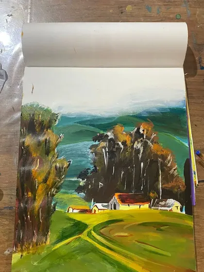 The full view of a landscape practice painting. Using a sketchbook for these studies allows students to experiment with color mixing and composition freely.